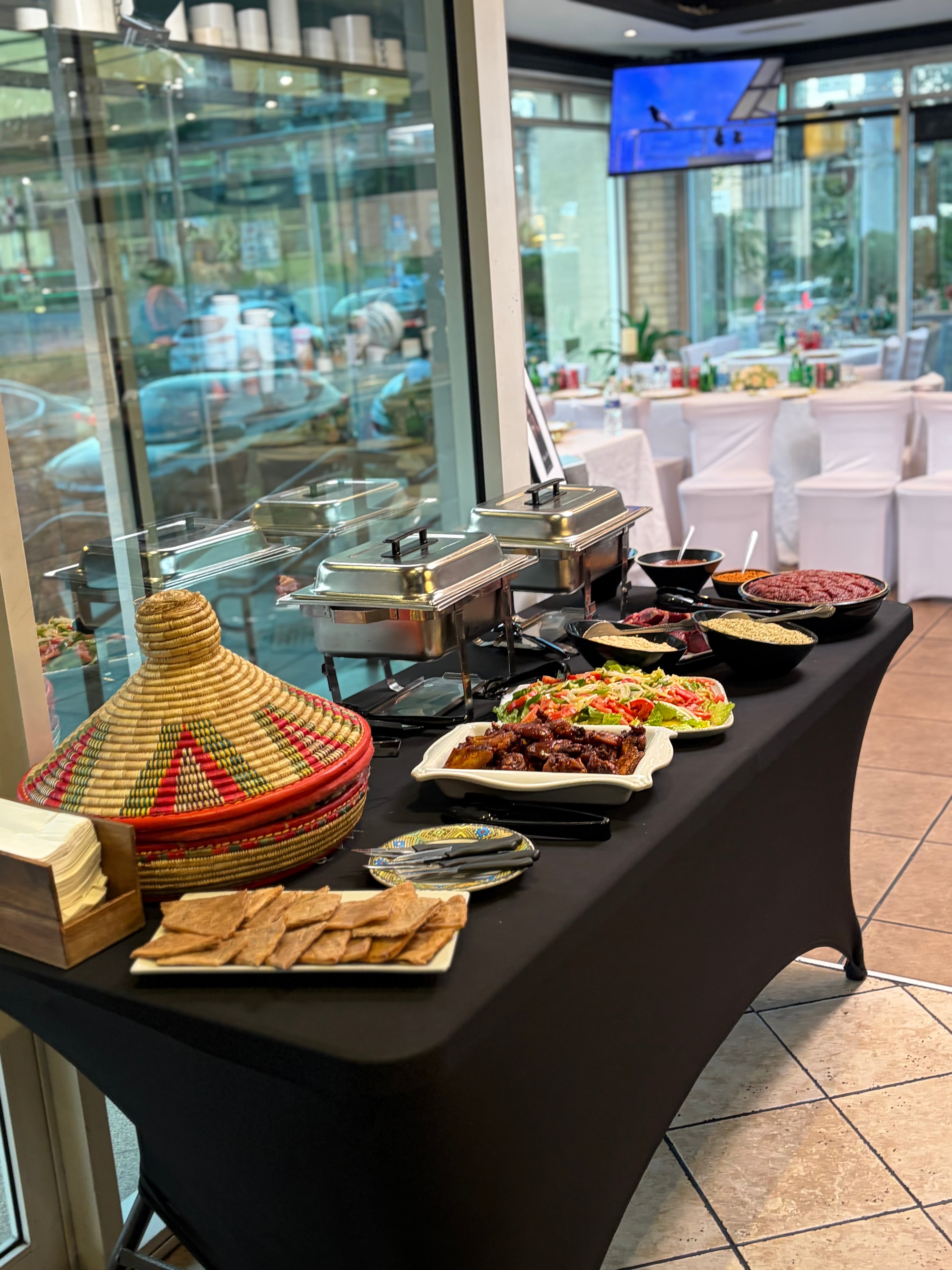 Sheger Spring Cafe catering buffet with Ethiopian dishes and mesob basket